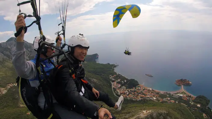 Tandem paragliding view of Sveti Stefan island and the Adriatic coast