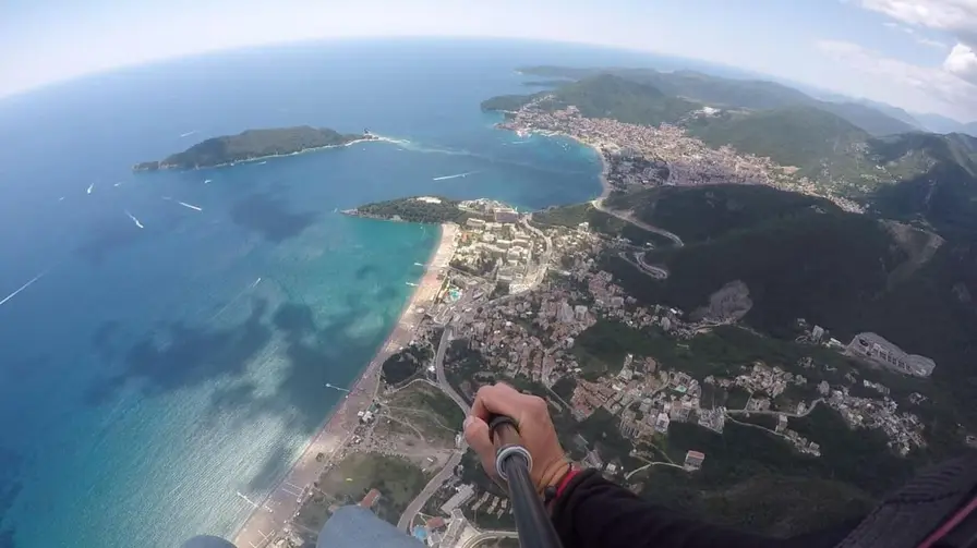 Tandem paragliding above the Budva Riviera — sea and coast below
